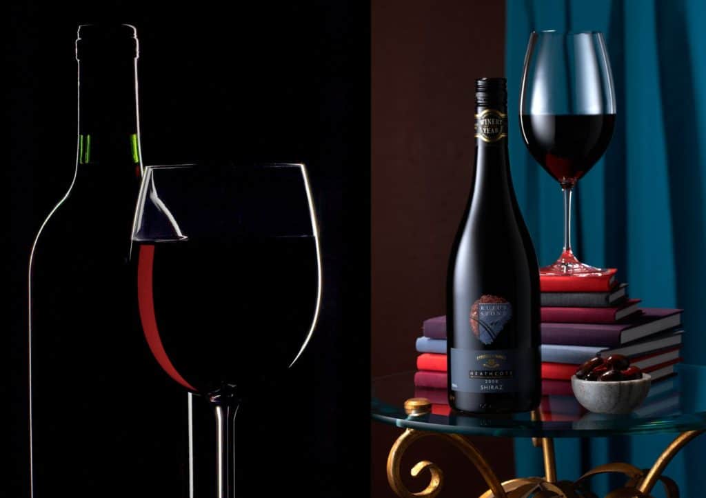 bottle and glass of wine displayed on a table with books