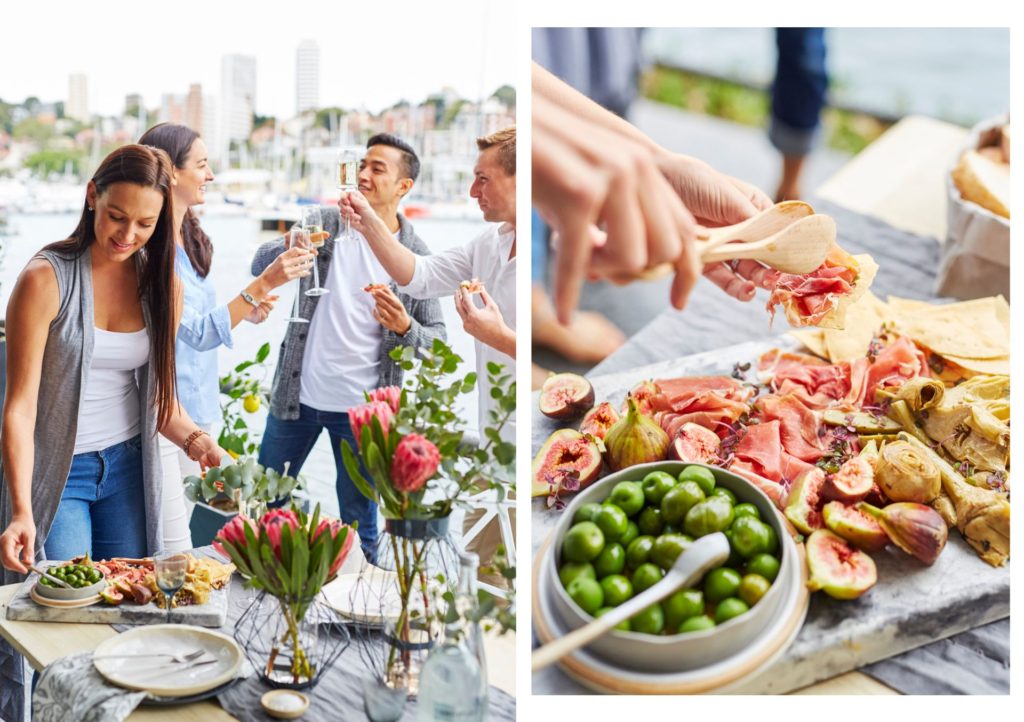 people gathered around food on a table