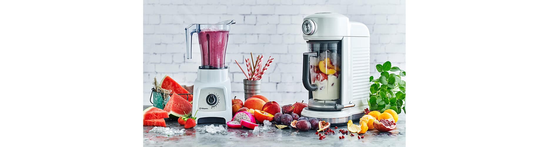 a blender and a food processor on a table full of different fruits