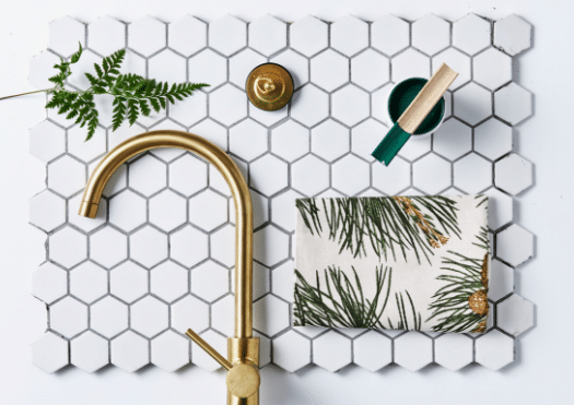 flat lay photography of a gold faucet and fern