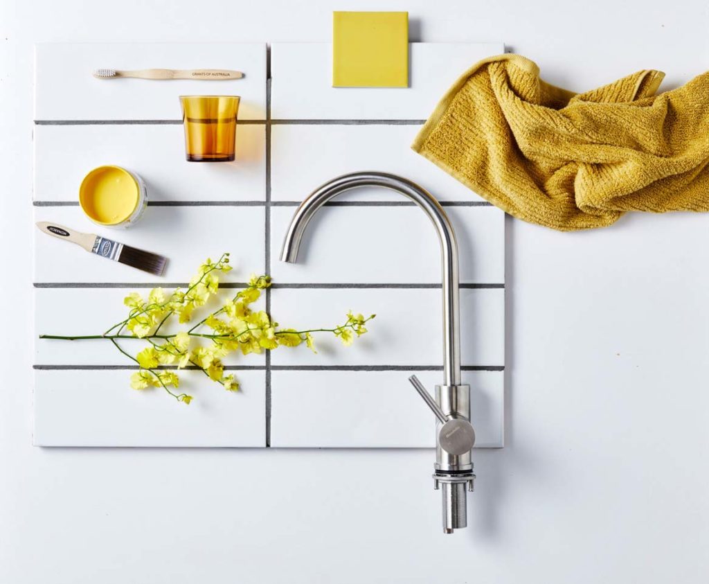 flat lay photography yellow theme with faucet, rag, and paint