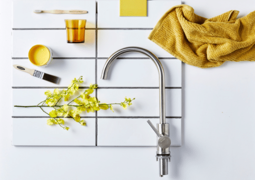 flat lay photography yellow theme with faucet, rag, and paint