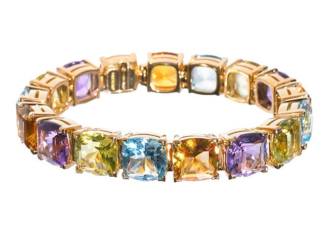 a gold bracelet with different coloured stones