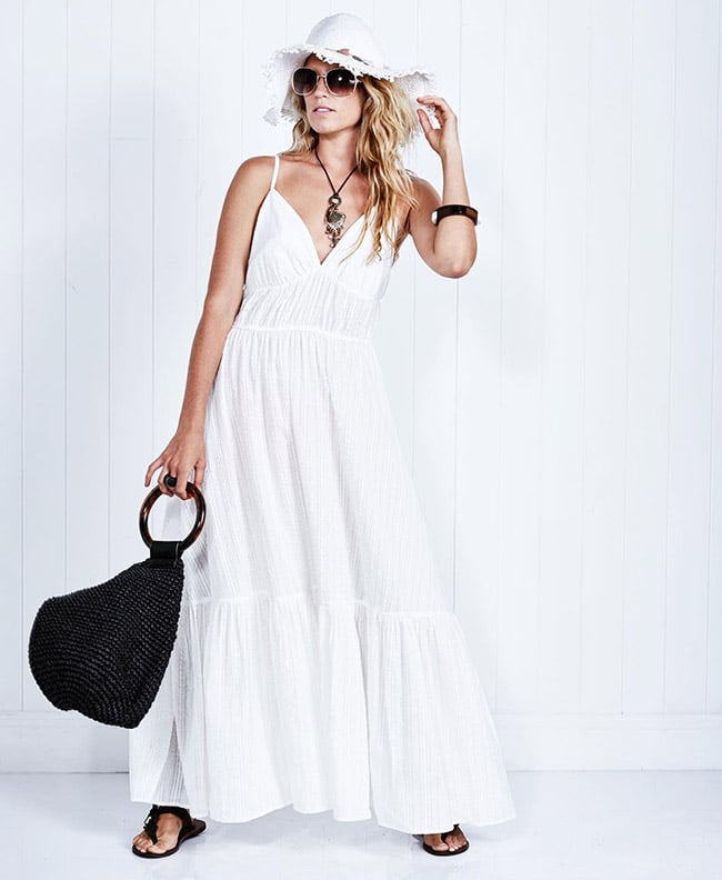 lady in white dress with sunglasses and a black hand bag