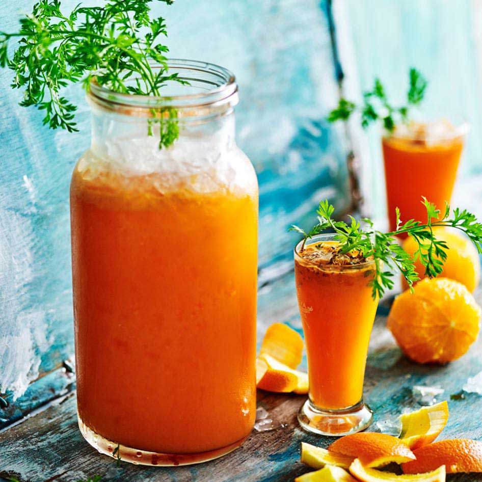 iced orange drink in a glass and a jar